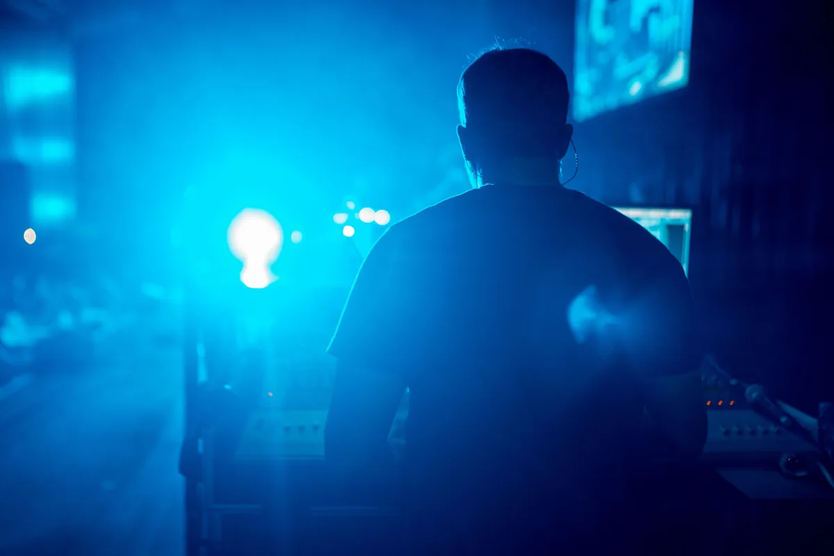 Shadowfax Audio technician working at monitor world during a live concert